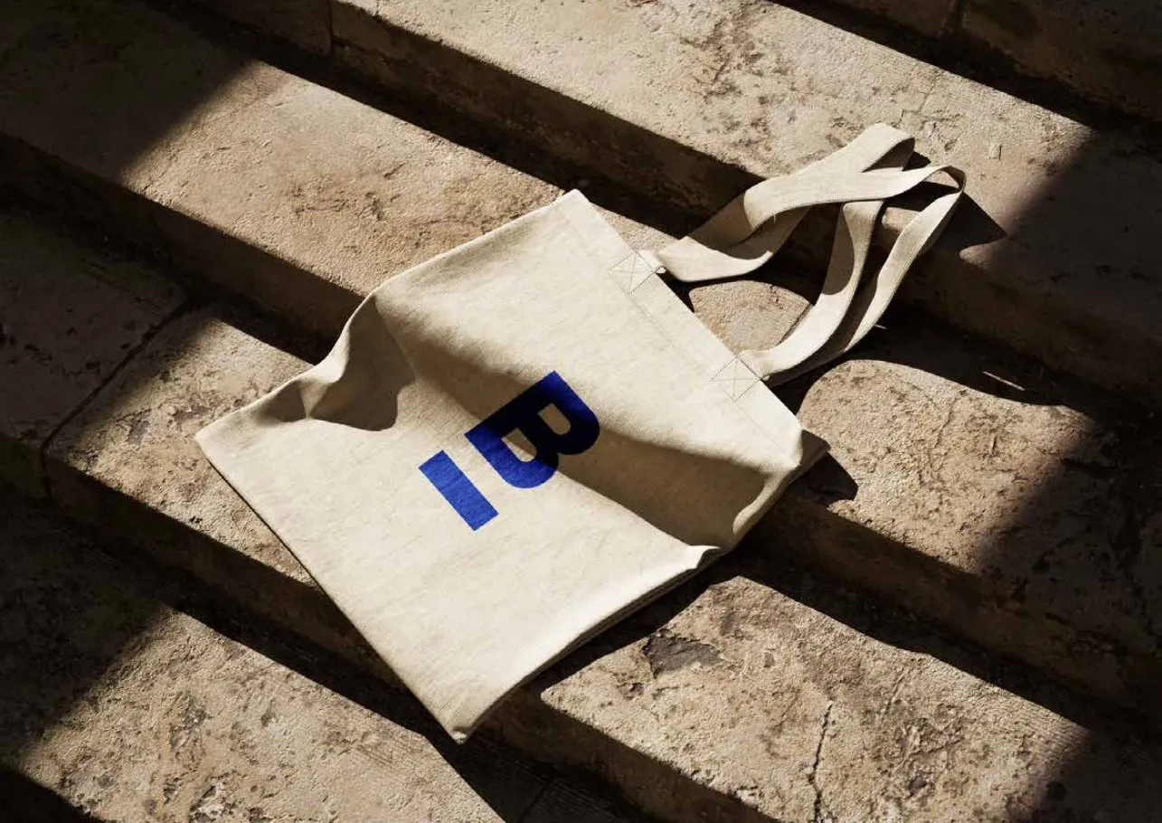 Canvas tote bag with the blue B mark on stone steps