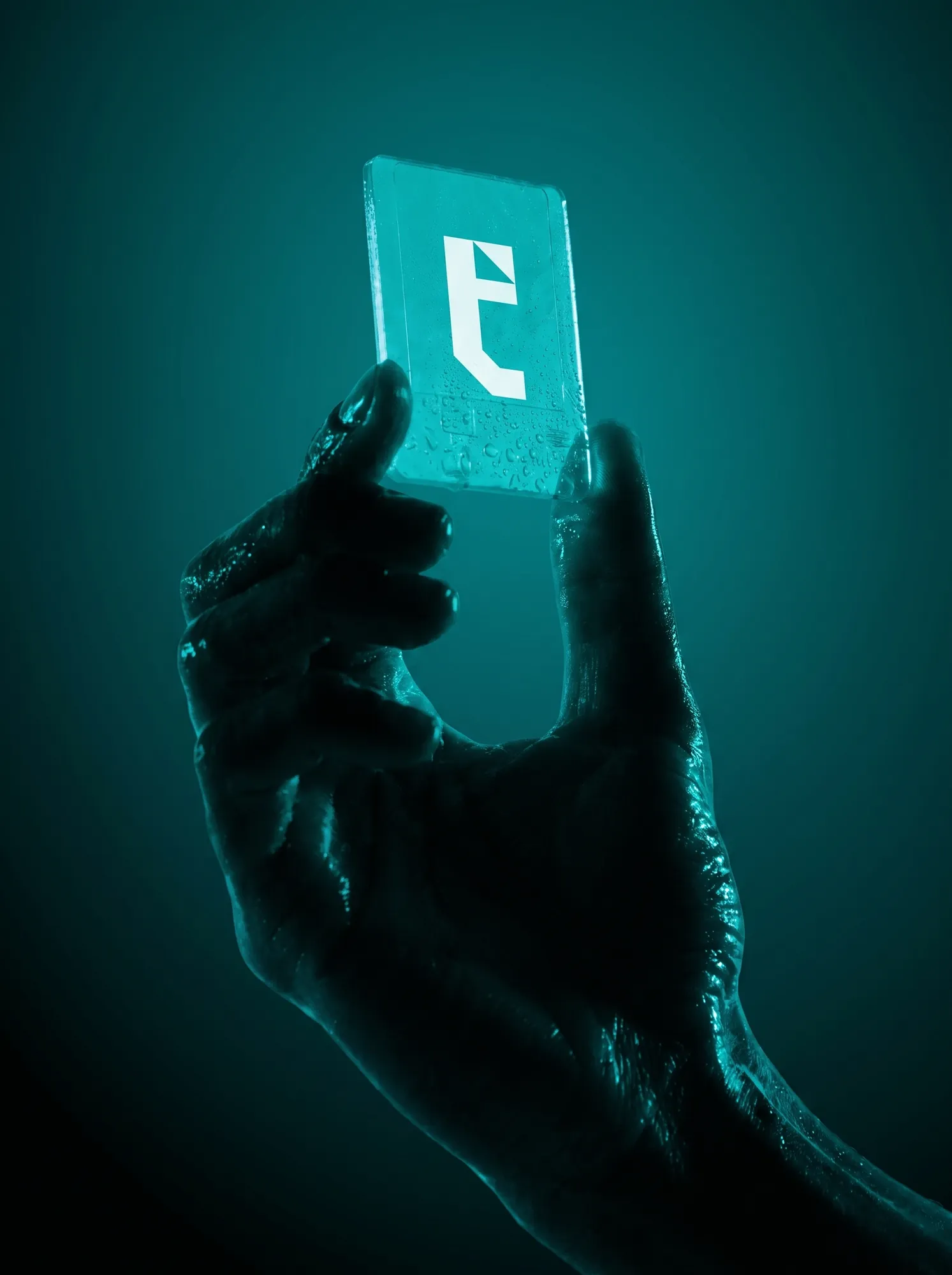 Hand holding a glowing teal card with the t icon
